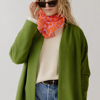 Woman wearing a wool coatigan with jeans and a white sweater