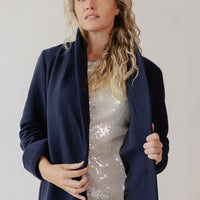 Woman staying warm in a navy blue dress coat