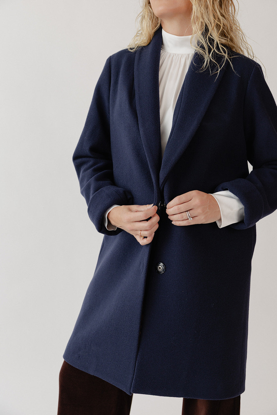 Close up view of woman wearing a navy blue wool coat