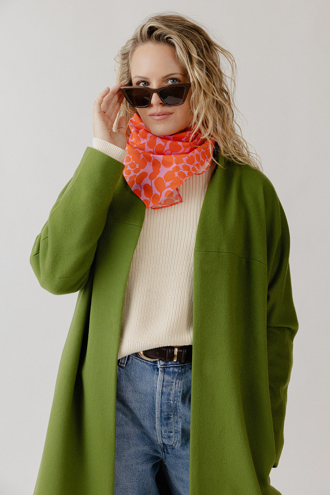 Woman wearing a wool coatigan with jeans and a white sweater