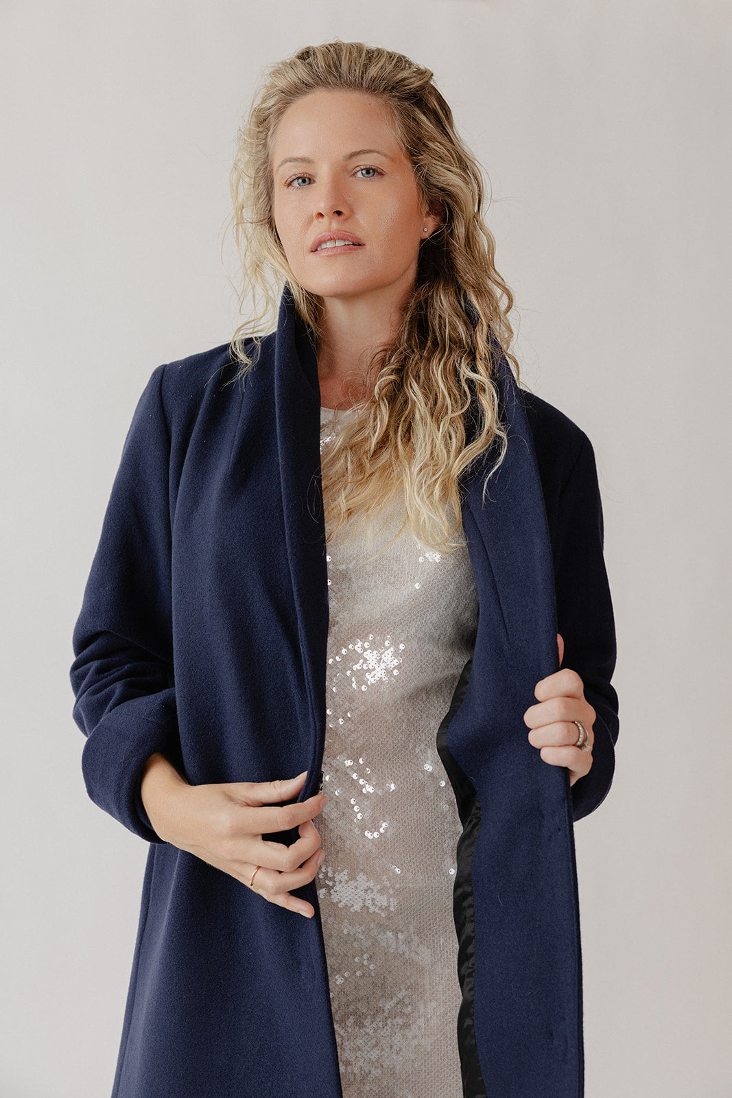 Woman staying warm in a navy blue dress coat